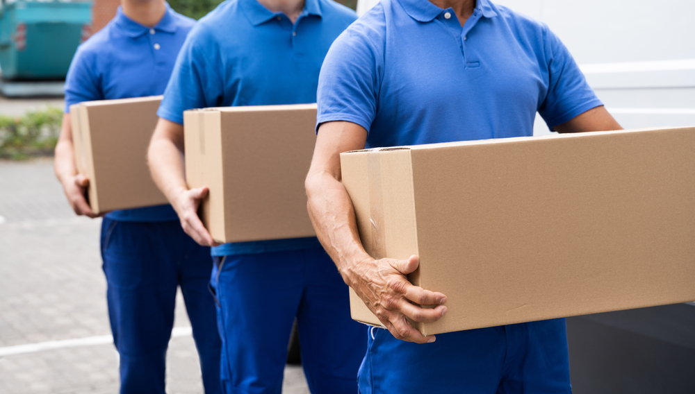 Long distance movers carrying moving boxes.