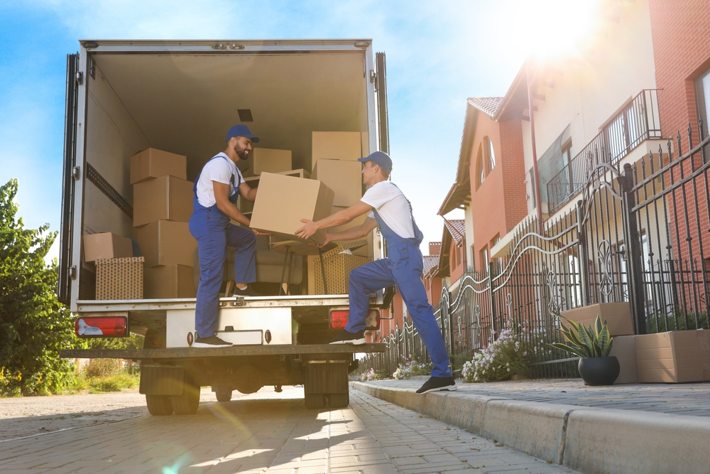 Movers loading boxes into a moving truck for moving.